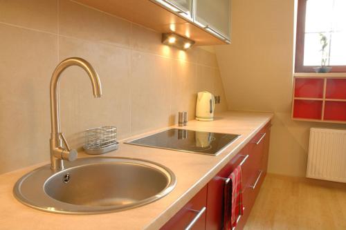 a kitchen with a sink and a counter top at Apartment 28 Rubinowy Pod Aniołem in Kazimierz Dolny