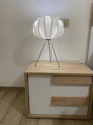 a white chair sitting on top of a wooden table at Appartamento Valle in Valledoria
