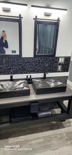 a bathroom counter with a sink and a mirror at Staycation Oasis! a unique Experience! Heated pool open until October 31st in Easton