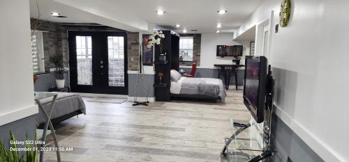a living room with a television and a bedroom at Staycation Oasis! a unique Experience! Heated pool open until October 31st in Easton