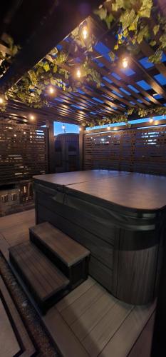 a bar with a wooden counter and some stairs at Staycation Oasis! a unique Experience! Heated pool open until October 31st in Easton