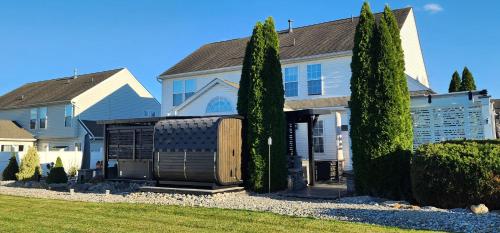 a white house with trees in front of it at Staycation Oasis! a unique Experience! Heated pool open until October 31st in Easton