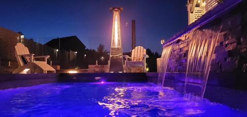 a water fountain in front of a building with a tower at Staycation Oasis! a unique Experience! Heated pool open until October 31st in Easton