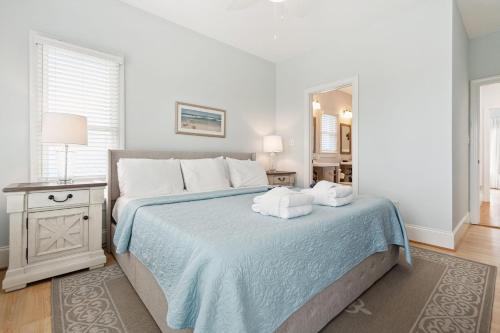 a bedroom with a bed with two towels on it at Oceanfront w Pool Panoramic Deck Views 5BDR Folly Ocean Breeze by AvantStay in Folly Beach