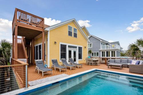 a house with a swimming pool and a deck at Oceanfront w Pool Panoramic Deck Views 5BDR Folly Ocean Breeze by AvantStay in Folly Beach