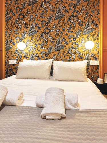 a bedroom with a bed with towels on it at Hôtel Gallia in Aix-les-Bains