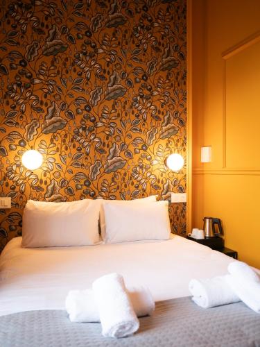 a bedroom with a bed with two towels on it at Hôtel Gallia in Aix-les-Bains