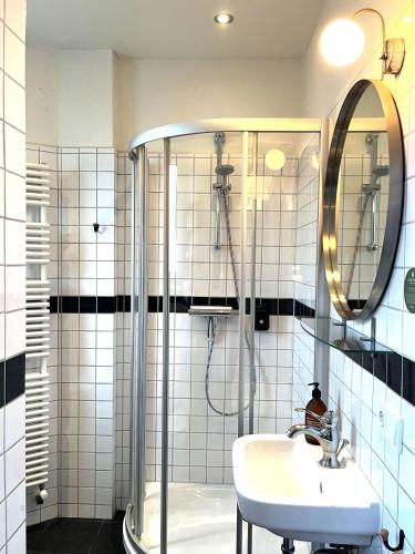 a bathroom with a shower and a sink at Logis Pastis in Maastricht