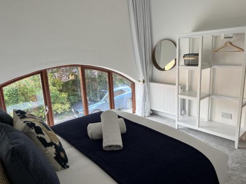 a bedroom with a bed with a large window at No1 Little Barrow Barns - Sleeps 10 in Chester