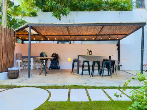 a patio with a table and chairs under a pavilion at Soul Dream Bonita in Las Terrenas