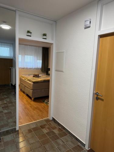 a room with a bed and a room with a door at Penthouse Central Apartment in Marl