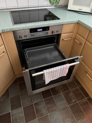 a kitchen with an oven with a towel in it at Penthouse Central Apartment in Marl