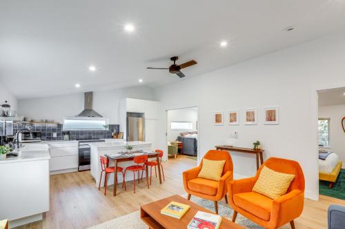 a kitchen and living room with orange chairs and a table at Less Than 1 Block to City Park New-Build Apt in Denver! in Denver