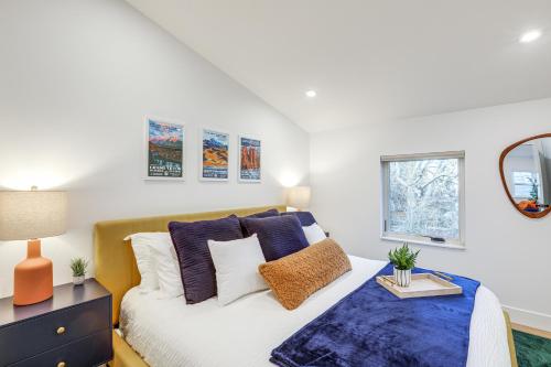 Schlafzimmer mit einem Bett mit blauen und weißen Kissen in der Unterkunft Less Than 1 Block to City Park New-Build Apt in Denver! in Denver