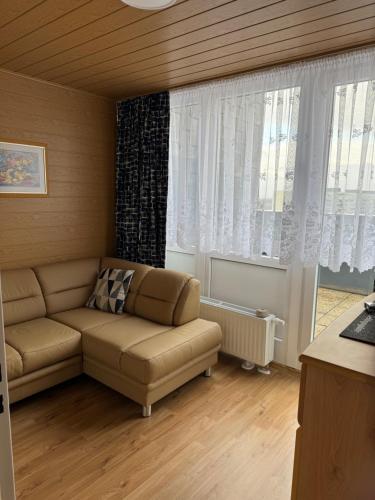 a living room with a couch and a window at Penthouse Central Apartment in Marl