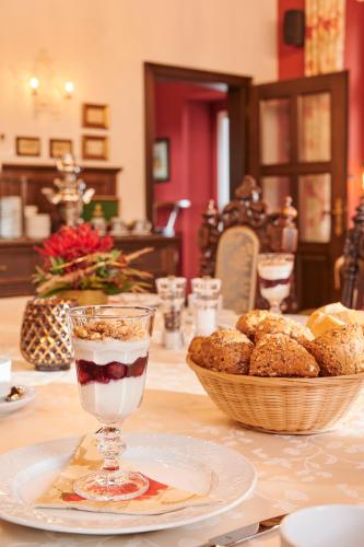 a table with a bowl of pastries and a drink at Hotel Anno 1848 in Lindern