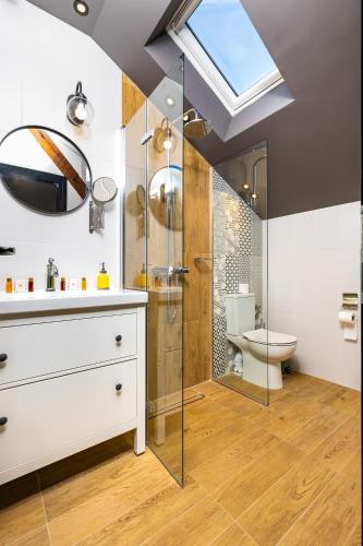 a bathroom with a shower and a sink and a toilet at Kapana Art Sky Studios Parking Included in Plovdiv