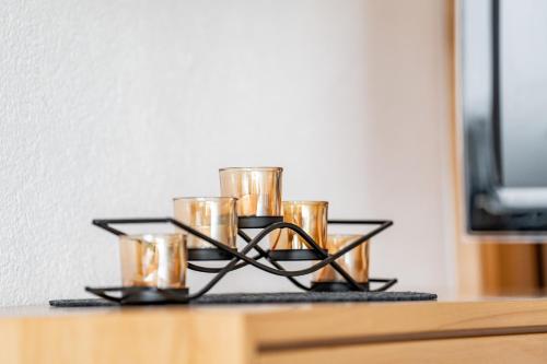 a tray with gold candles on a table at Hotel Garni Madrisa in Brand