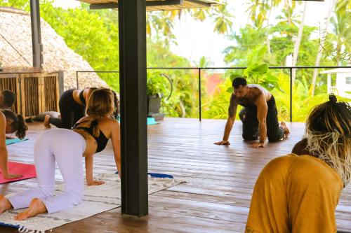 a group of people doing yoga on a deck at Soul Dream Bonita in Las Terrenas
