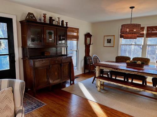 a living room with a wooden table and a couch at Rabbits Run Mountain Retreat in Mentone