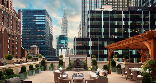 a patio with a fountain in the middle of a city at InterContinental New York Barclay Hotel by IHG in New York