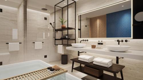 a bathroom with two sinks and a tub at Crowne Plaza Fiji Nadi Bay Resort & Spa by IHG in Nadi