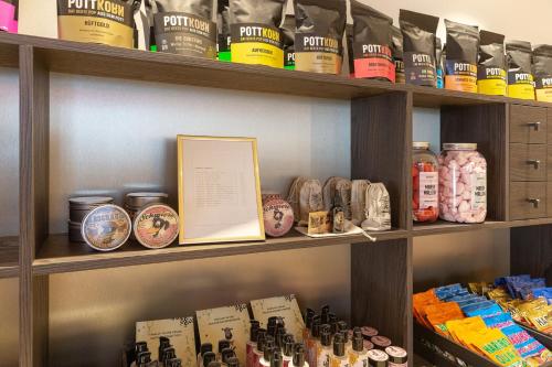 a shelf filled with lots of jars of food at Holiday Inn - the niu, Flux Passau by IHG in Passau