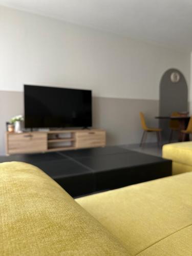 a living room with a flat screen tv and a couch at SnappyB Living Spaces in Alexandroupoli