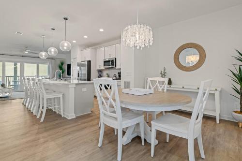 a kitchen and dining room with a table and chairs at Cambridge Reserve at Bermuda Bay by KEES Vacations in Kill Devil Hills