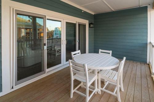 a table and chairs on the porch of a house at Cambridge Reserve at Bermuda Bay by KEES Vacations in Kill Devil Hills