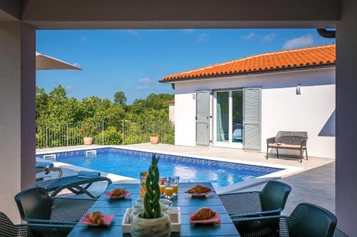 a villa with a swimming pool and a patio at Ferienhaus Nana in Marčana