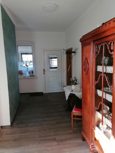 a room with a wooden cabinet and a table at Ferienwohnung Im Wachturm in Tangermünde