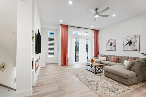 a living room with a couch and a tv at Modern 2BR l Pet-Friendly l Private Baths in Dallas