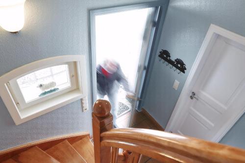 a person walking out of a door at Haus Möwennest in Midlum