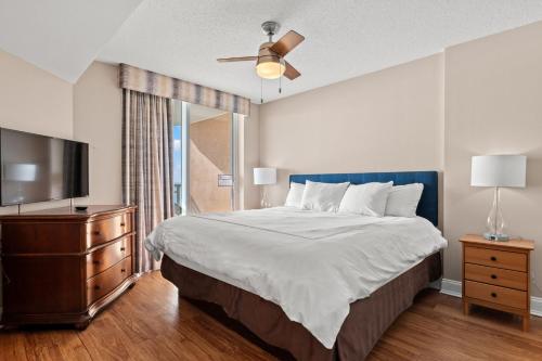 a bedroom with a bed and a flat screen tv at Bahama Sands 1204 in Myrtle Beach