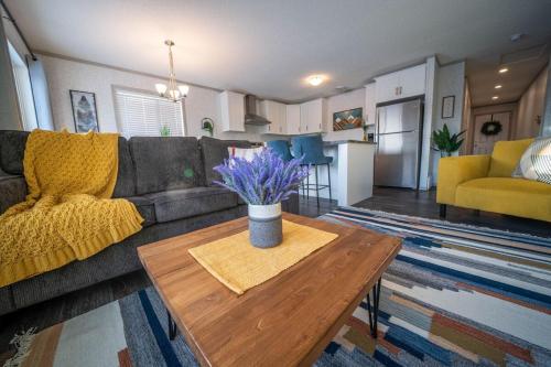 a living room with a couch and a table at 3 Bedroom Townhouse with Mountain Views, Large Deck, Garage in Invermere