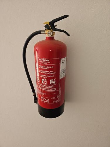 a red fire hydrant is attached to a wall at Privat Apartment with Pool View! in Santa Maria