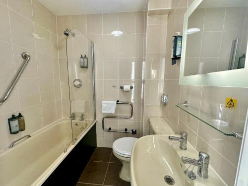 a bathroom with a sink and a toilet and a mirror at Carlisle Station Hotel, Sure Hotel Collection by BW in Carlisle
