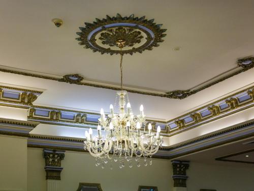 a chandelier hanging from a ceiling in a room at Palais Royale in Katoomba