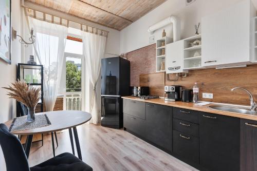 a kitchen with a table and a counter top at Odesa city center in Odesa