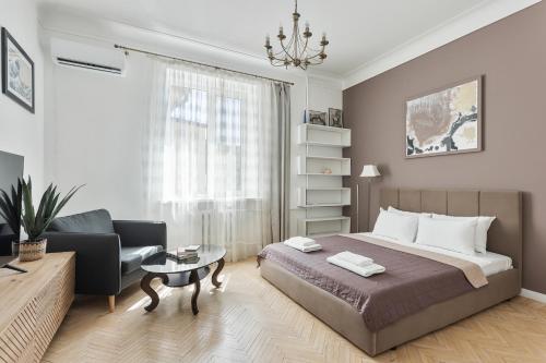 a bedroom with a bed and a living room at Odesa city center in Odesa
