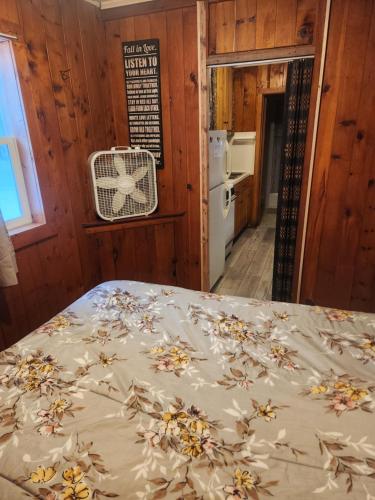 a bedroom with a bed with a bedspread with flowers on it at big kahuna in Steuben