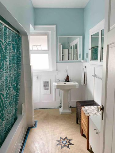a bathroom with a sink and a white sink at Craftsman Home in popular East Village in Vancouver