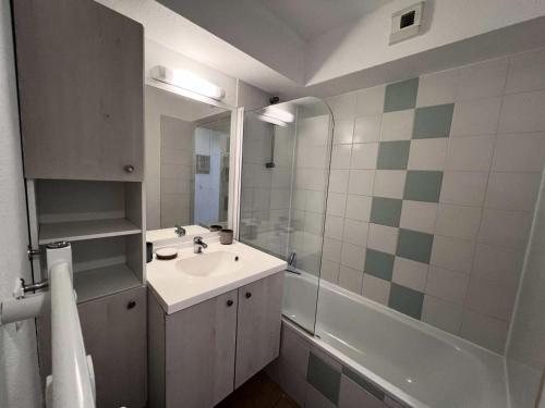 une salle de bain avec un lavabo et une douche dans l'établissement Résidence Le Cordouan - 116 - Bel appartement rénové avec goût dans une résidence 3 MAE-2881, à Soulac-sur-Mer