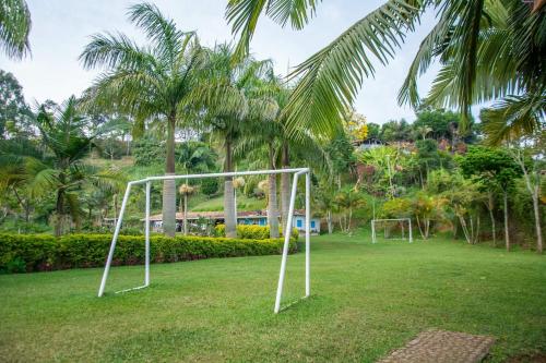 a soccer goal in a field with palm trees at Finca Panorama Jerico in Jericó