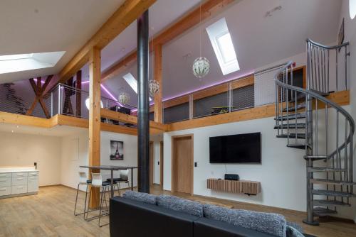a living room with a couch and a staircase at Turmhus in Bürs