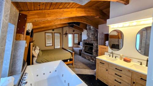 a bathroom with a bed and a tub and a sink at Coalition Lodge in Park City