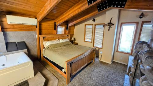 a bedroom with a bed and a tub in a cabin at Coalition Lodge in Park City