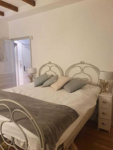 a bedroom with a bed with two metal headboards at Villa Acacia in Vallauris