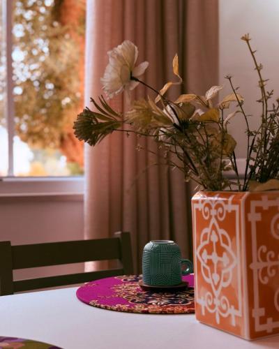 a table with a vase with flowers on it at Relais San Giovanni srls in Castellaneta